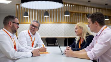 four-EMCOR-UK-colleagues-sitting-in-communal-workspace.jpg