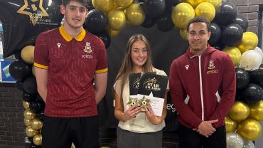 2.-Faye-Oxley-receiving-her-awards-with-BCFC-players-Zac-Hadi-and-Lewis-Richards-e1747842991769.jpg